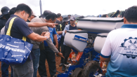Event attendees checking out farm equipment