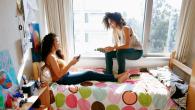 Two students in a dorm room.