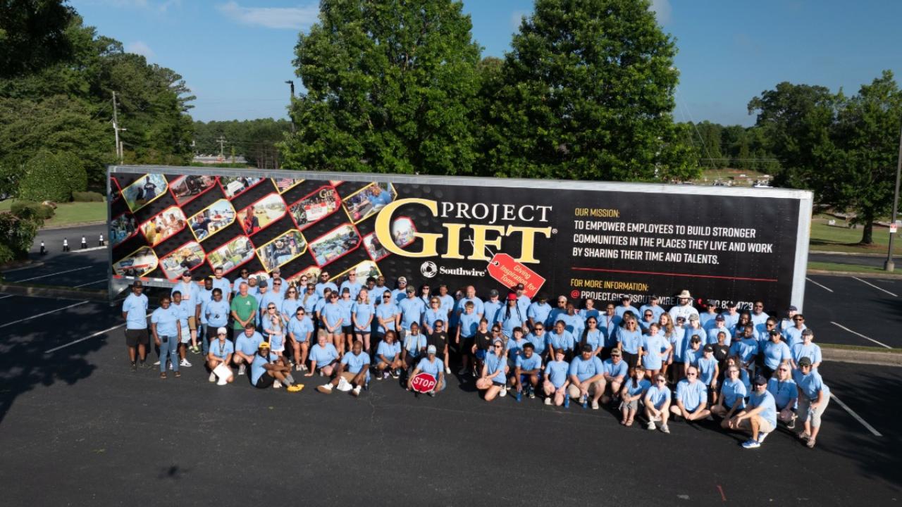 Group photo of Southwire volunteers in front of Project GIFT trailer