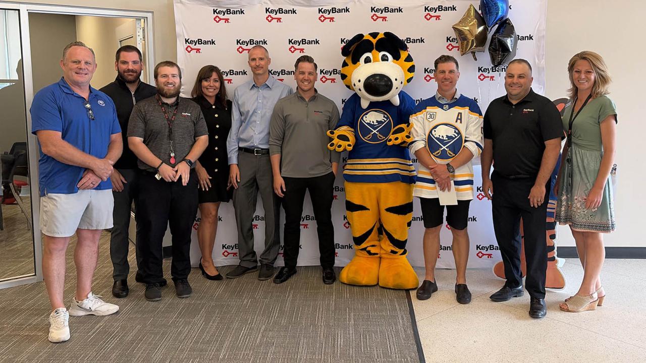 People standing together with Sabres mascot