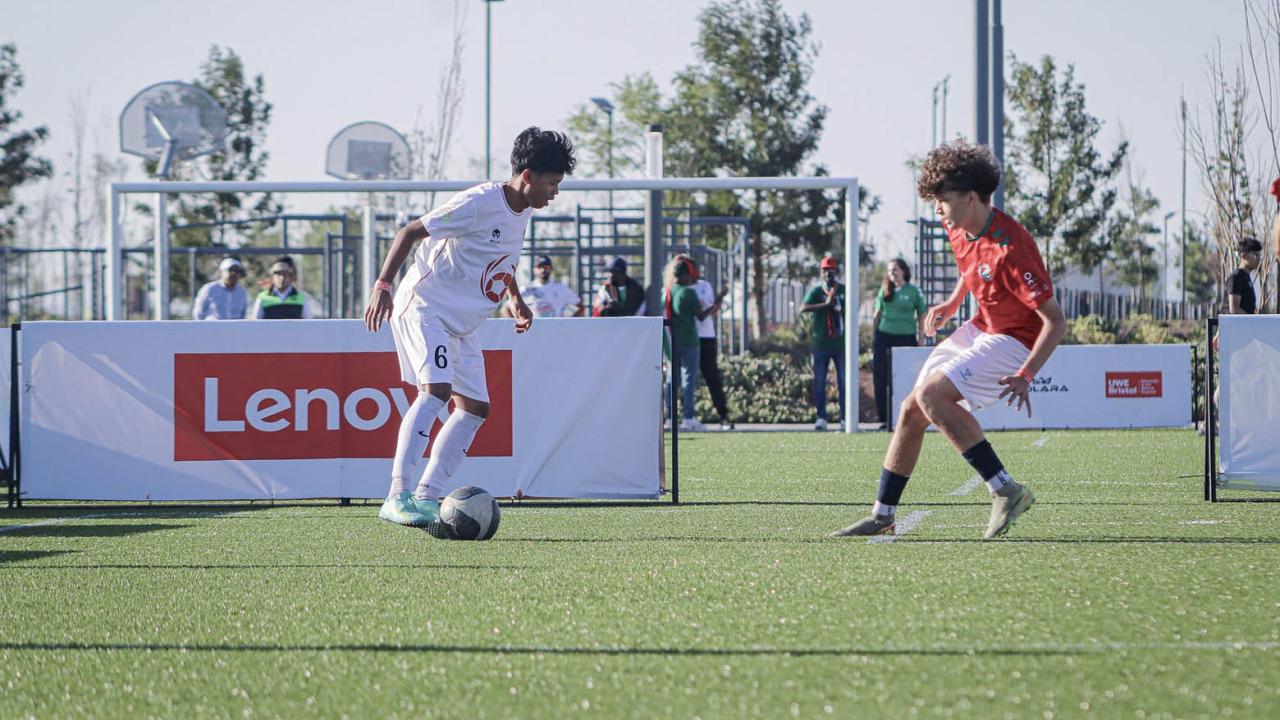 2 young people playing soccer