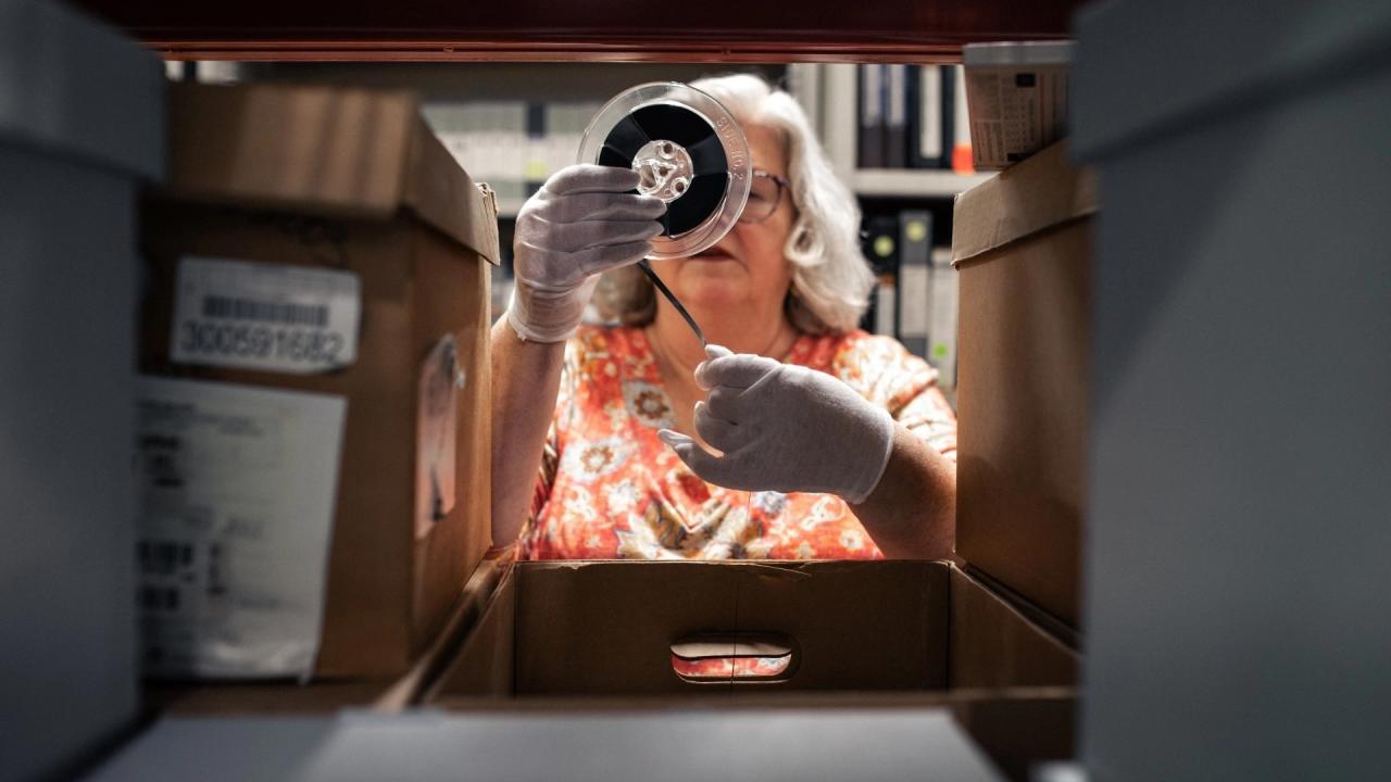 Lori winding up negatives on a roller