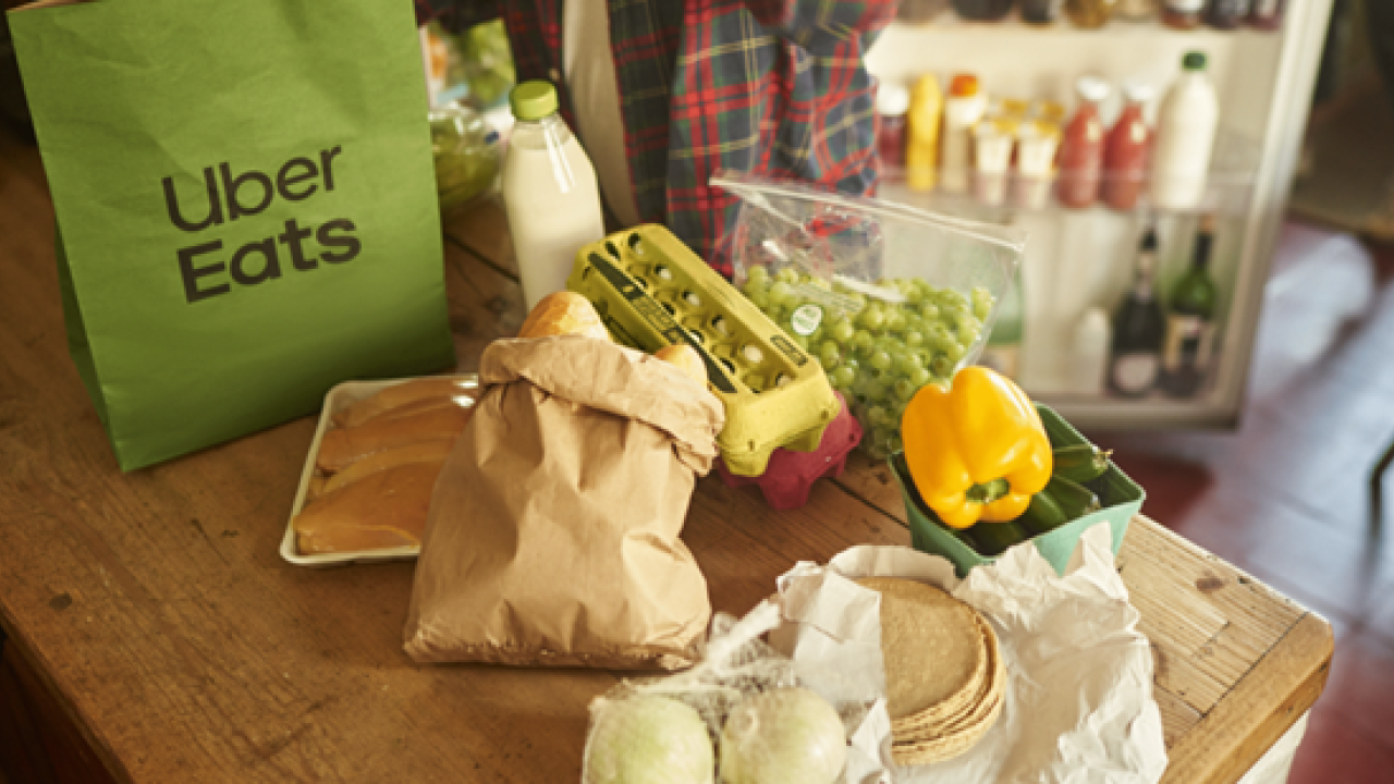 A table with food on it and a bag that reads "Uber Eats"