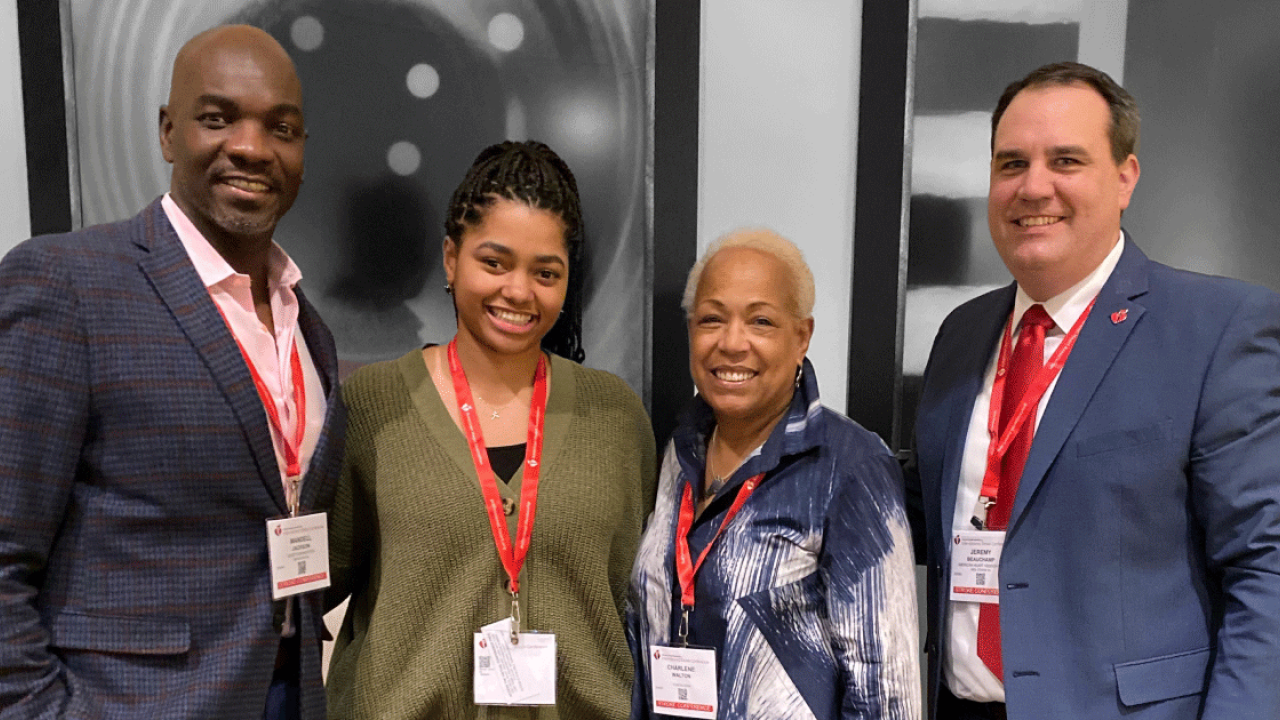 4 people wearing conference name tags