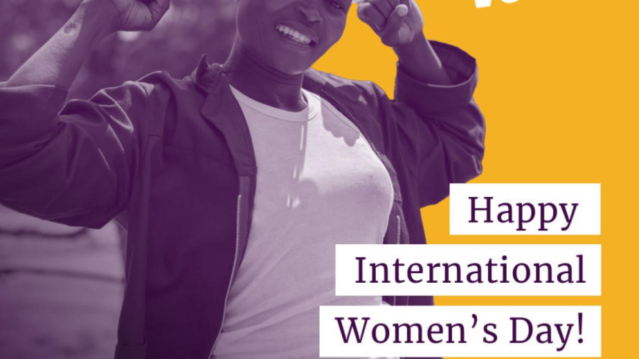 Woman in hard hat with text that reads: Her Voice - Happy International Women's Day