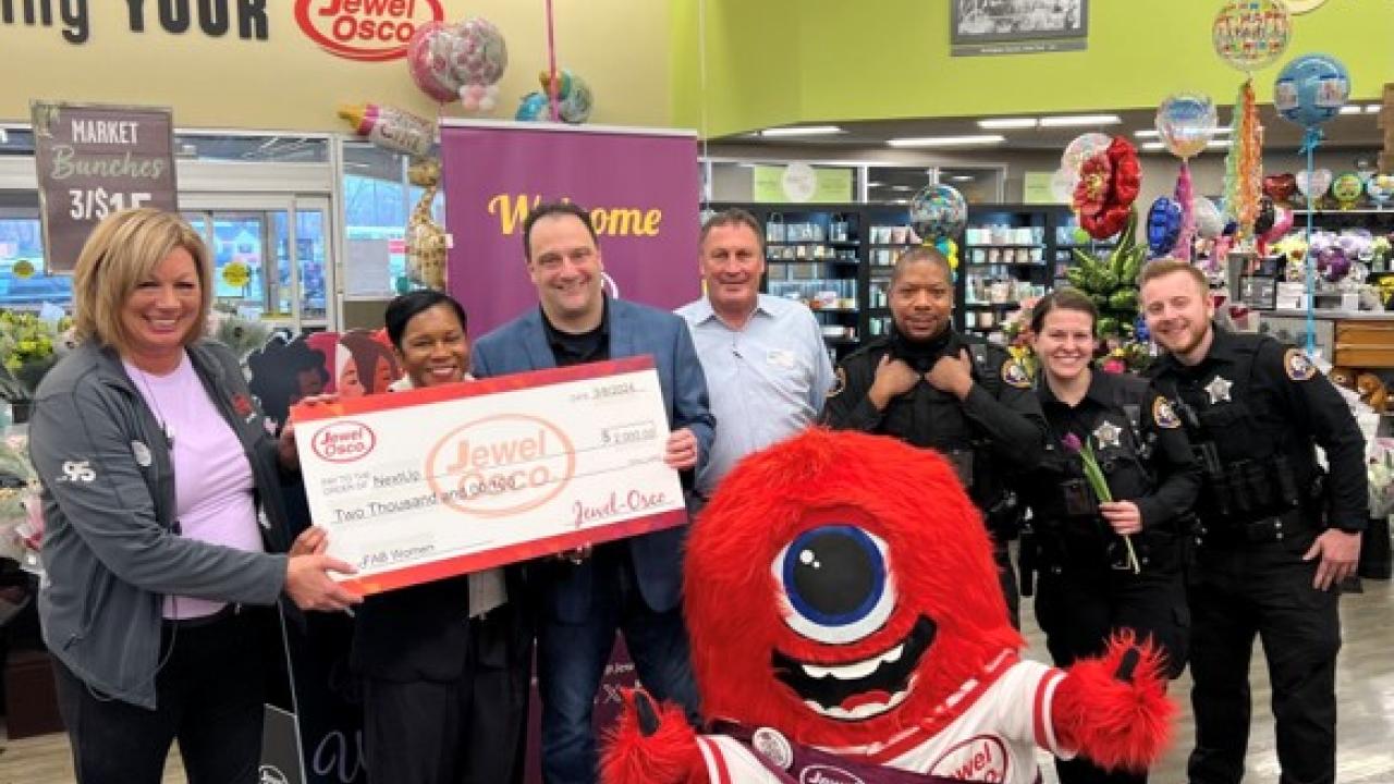 Group of people holding a check in a Jewel-Osco store