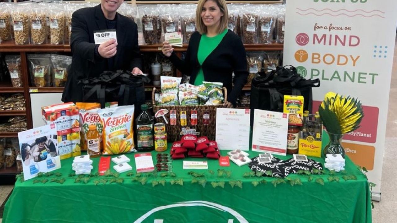 People posing at booth at Jewel-Osco Mind, Body, Planet event