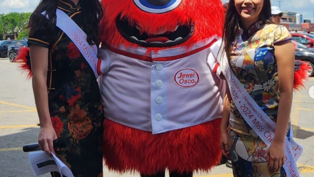 Albertsons Companies' Jewel-Osco Mascot posing with two people in traditional AAPI attire