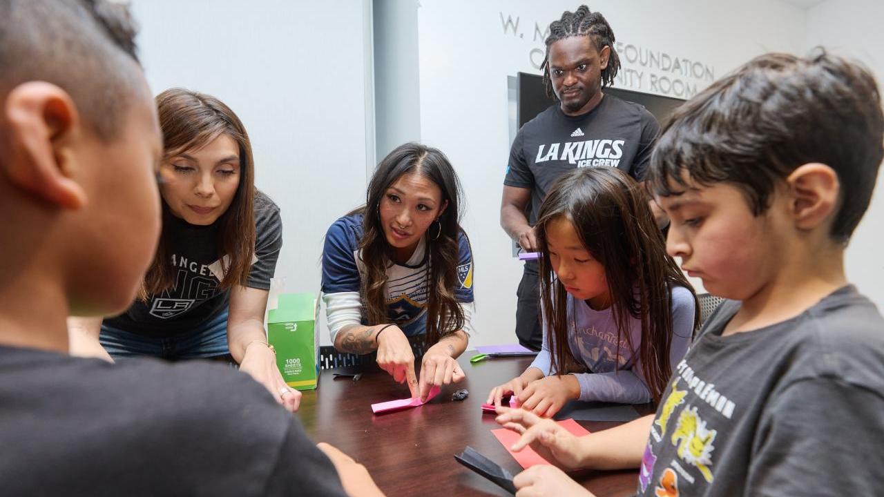 Children from Little Tokyo Service Center learn about hockey with the LA Kings Ice Crew.
