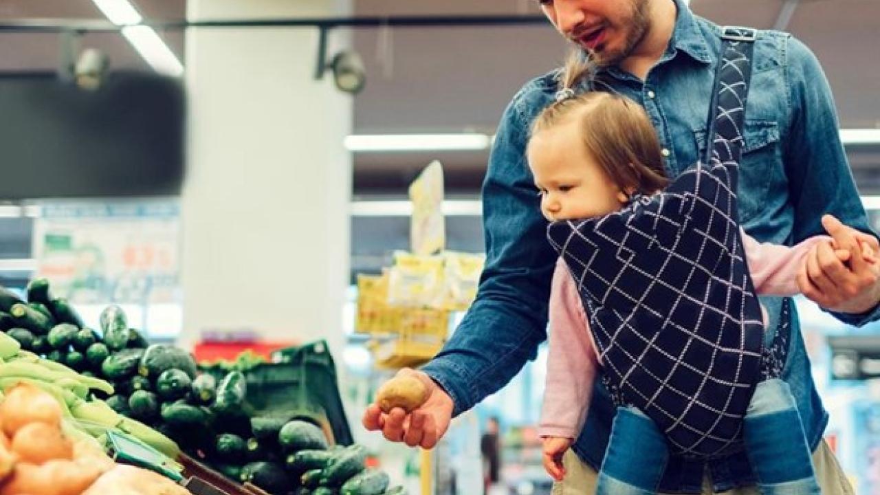 Parent holding child in grocery store