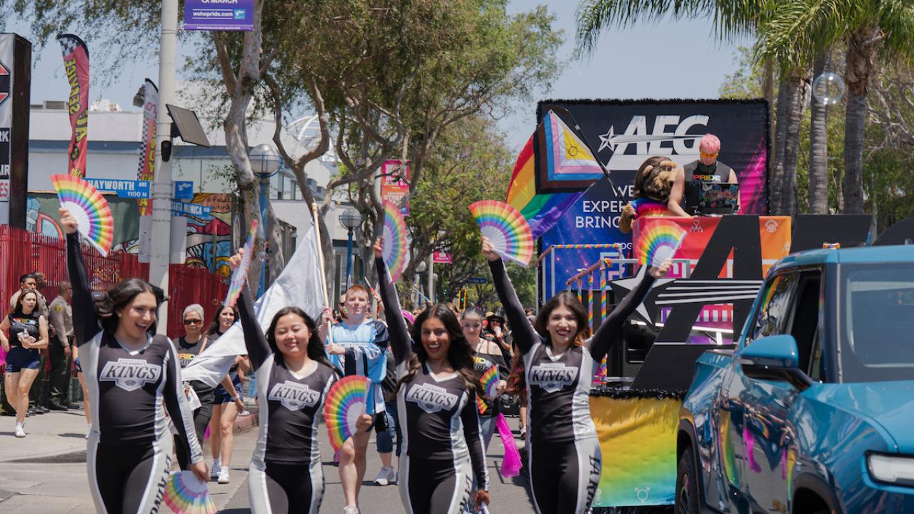 LA Kings Ice Crew march in front of AEG Pride float