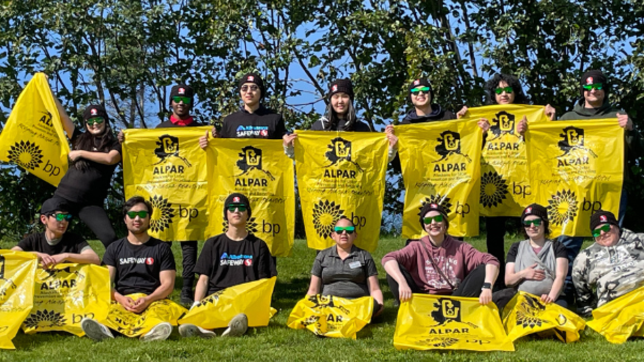 Picture of the Albertsons Companies' Homer, Alaska team outside holding Alaskans for Litter Prevention and Recycling (ALPAR) banners