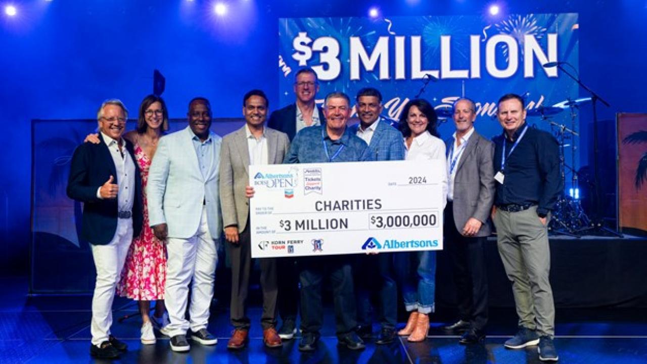 Group of people holding a check
