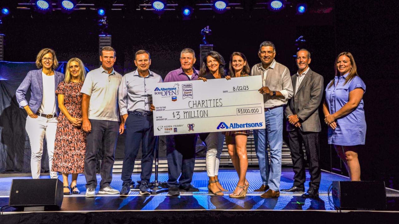 Group of people holding a check