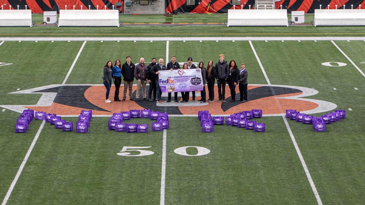 A group of people stood on a football pitch 