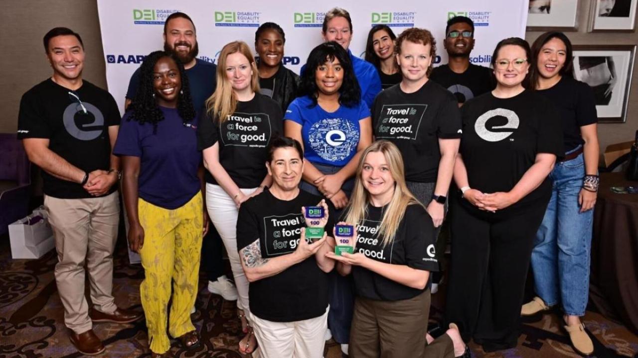 A group photo in front of a Disability:IN Conference back drop 