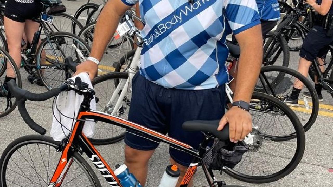 Terrance Hudson, Senior Manager of Store Optimization, stood with a bicycle