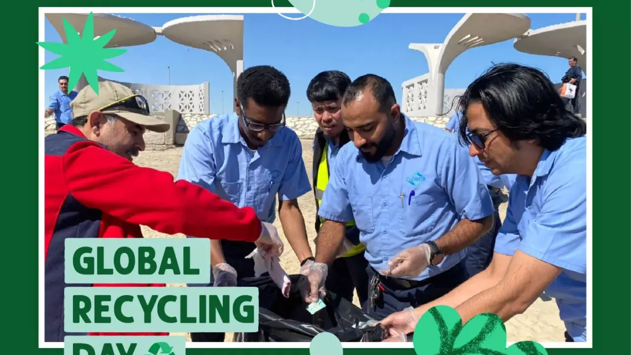 People placing things into a plastic bag: Global Recycling Day