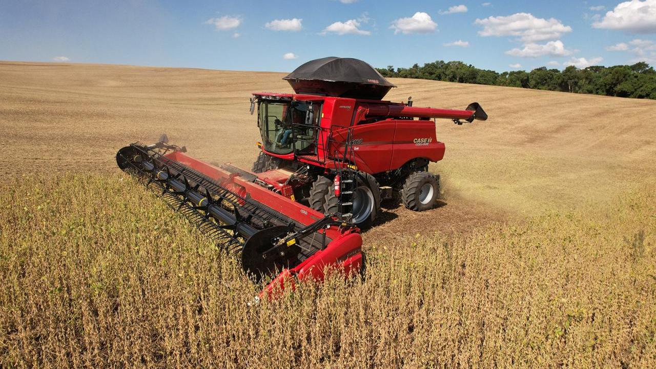 Red farm machine in a golden field