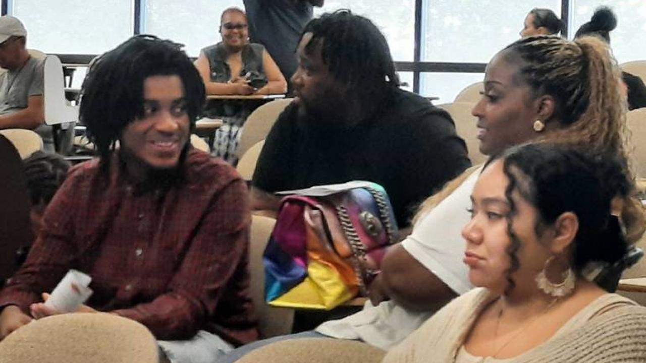 People talking in a classroom.
