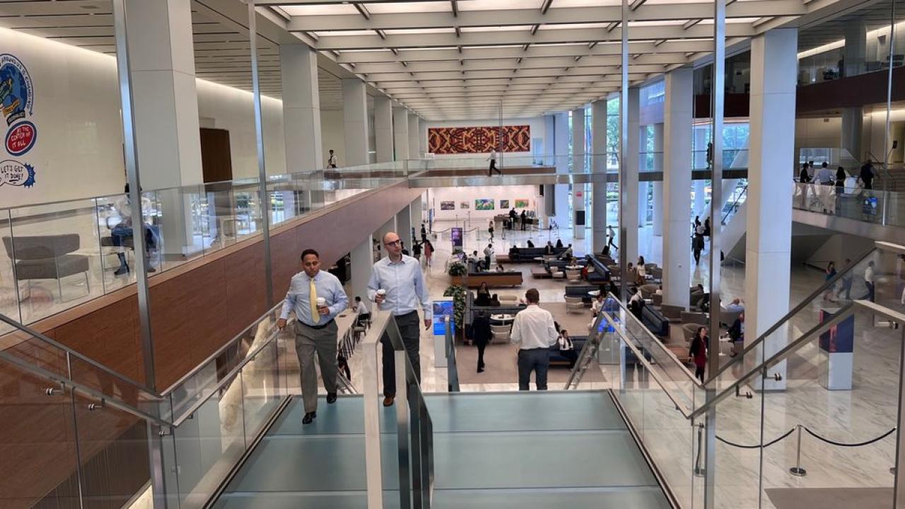 People on an escalator inside a building