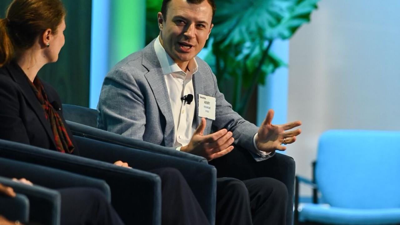 People seated in chairs on a stage and discussing