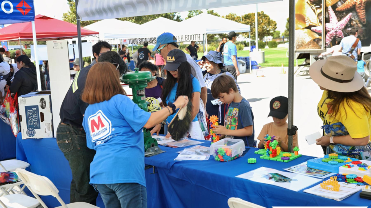 Kids and adults doing activities at an event table