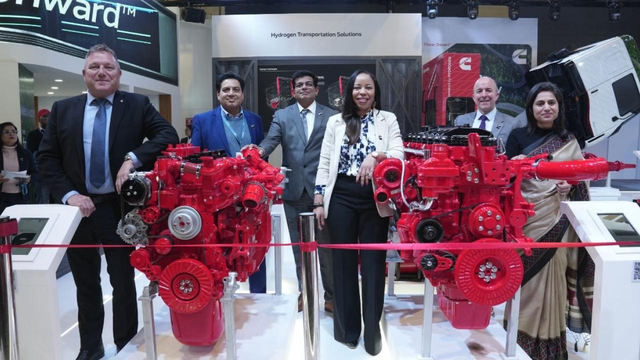 People posing with red engines