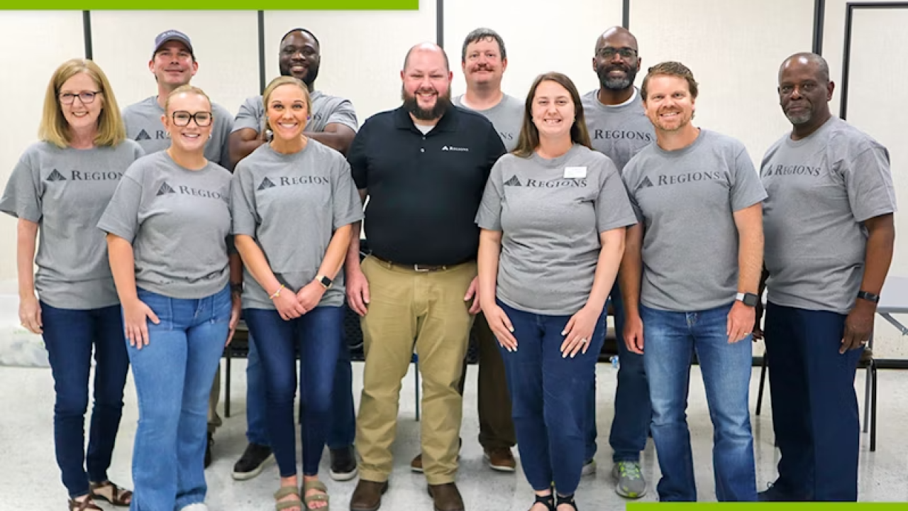 A group of people standing together in Regions Bank t-shirts