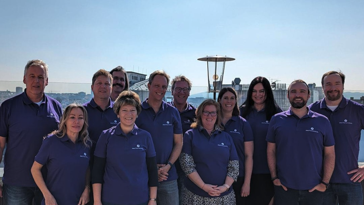 Employees wearing purple, in a group outside
