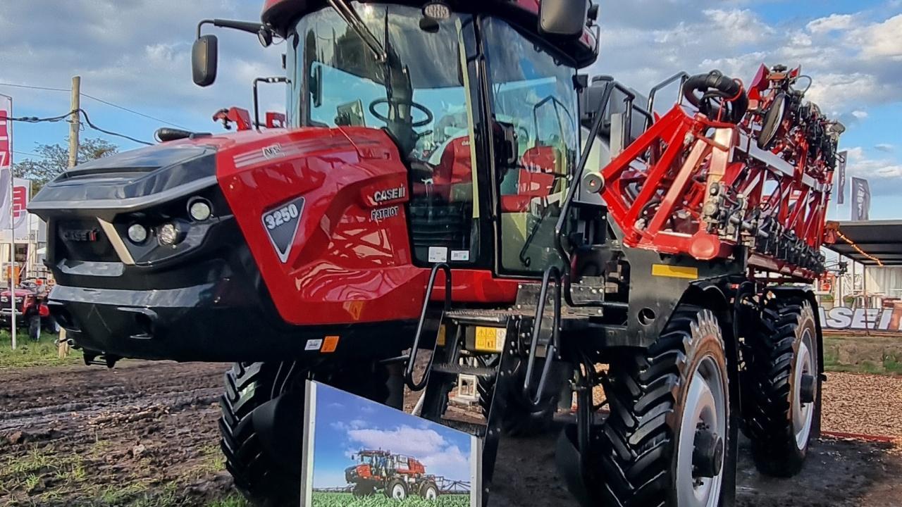 Tractors and equipment in a field under a cloudy sky