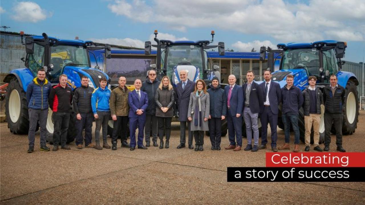 People standing together in front of blue machinery