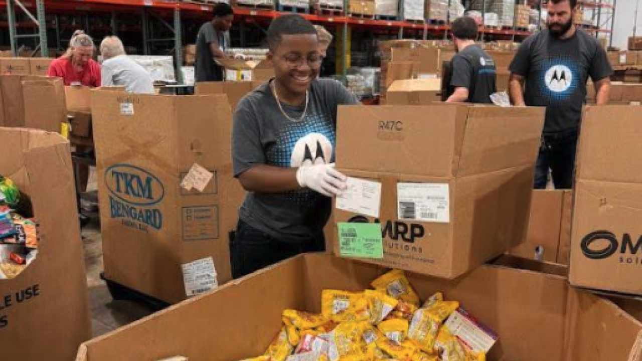 People in Motorola t-shirts working with boxes in a warehouse