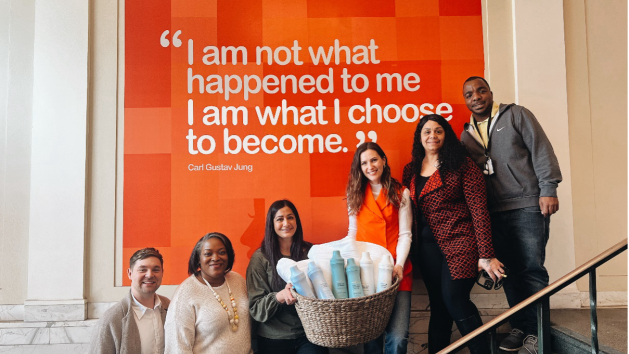 People standing on a stairway with a basket of products