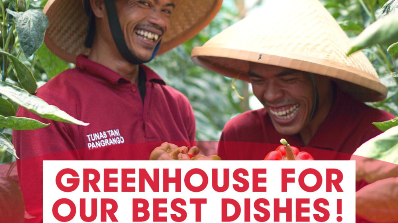 Two people smiling and holding produce, with words "Greenhouse for our best dishes!"