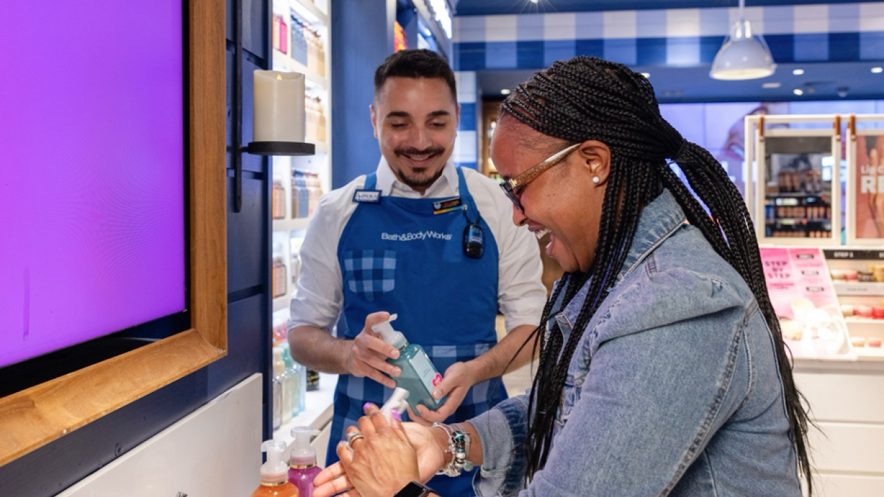 A Bath & Body Works employee helping a customer