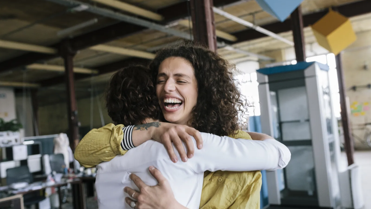 Two people embracing and smiling