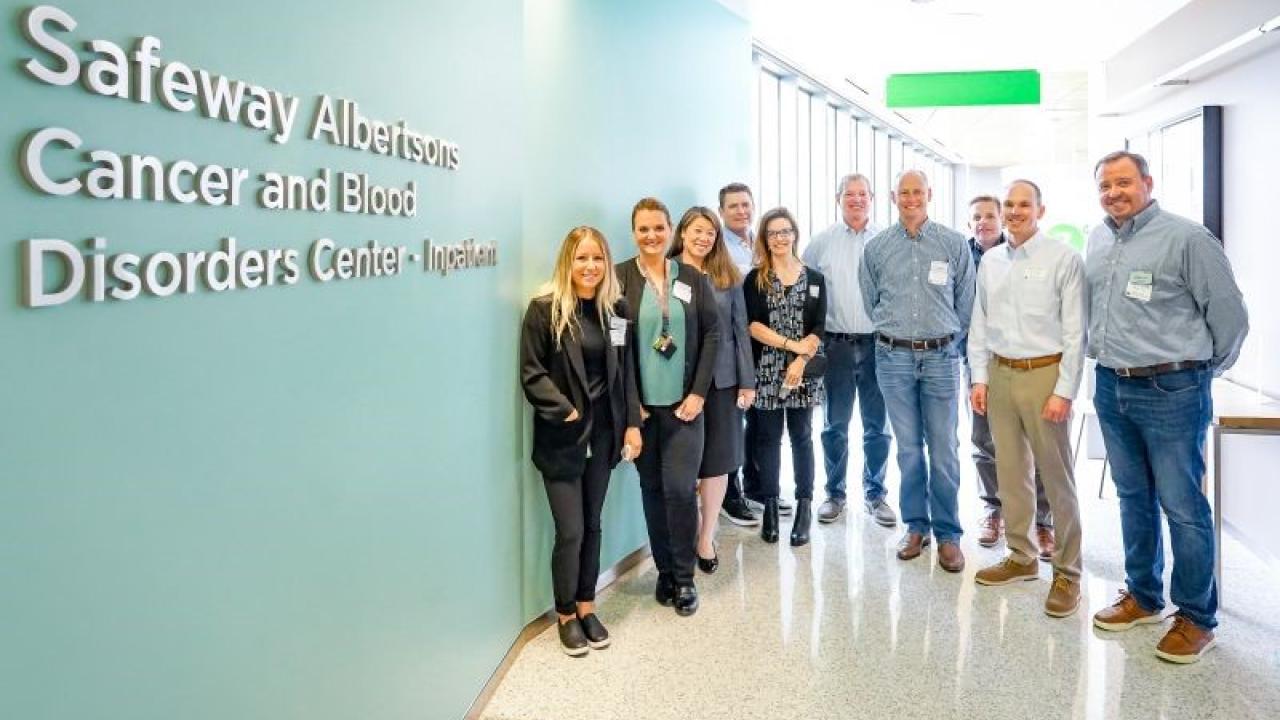 Group of people next to the new Safeway Albertsons Cancer and Blood Disorders Center sign