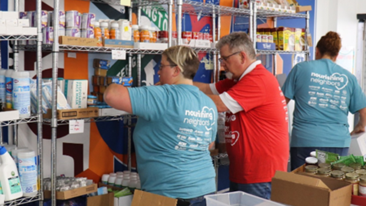 People stocking shelves in food pantry