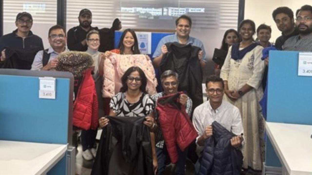 Group of people posing with winter coats