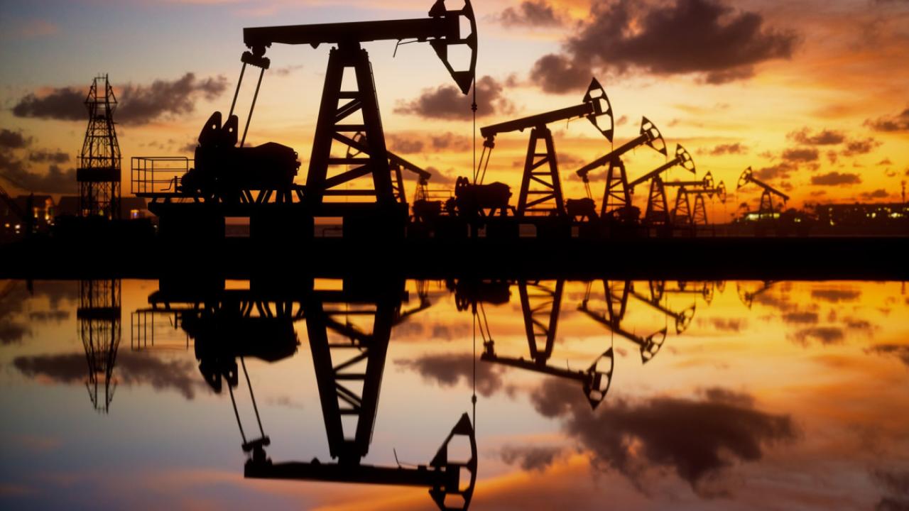 Oil wells with a sunset in the background