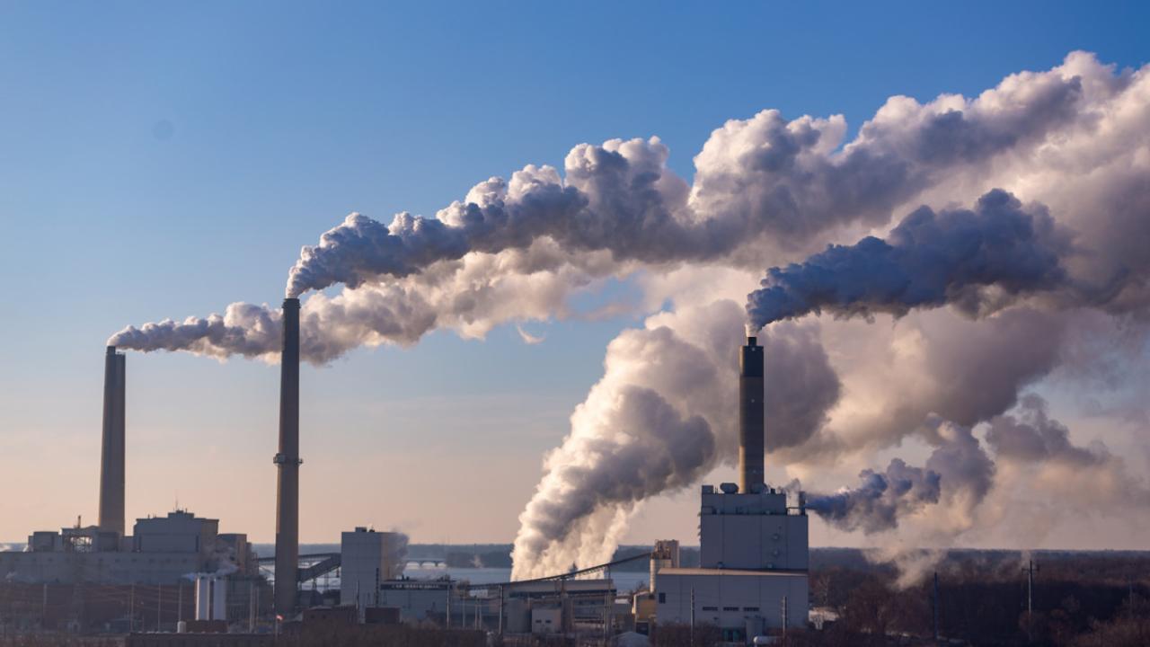 Emissions rising from facility smoke stacks