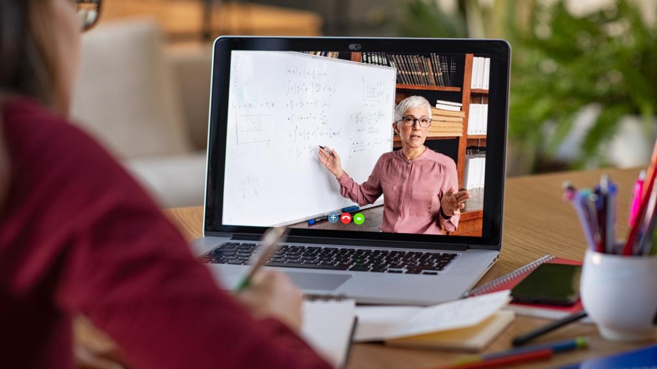 Woman teaching via a video call on laptop