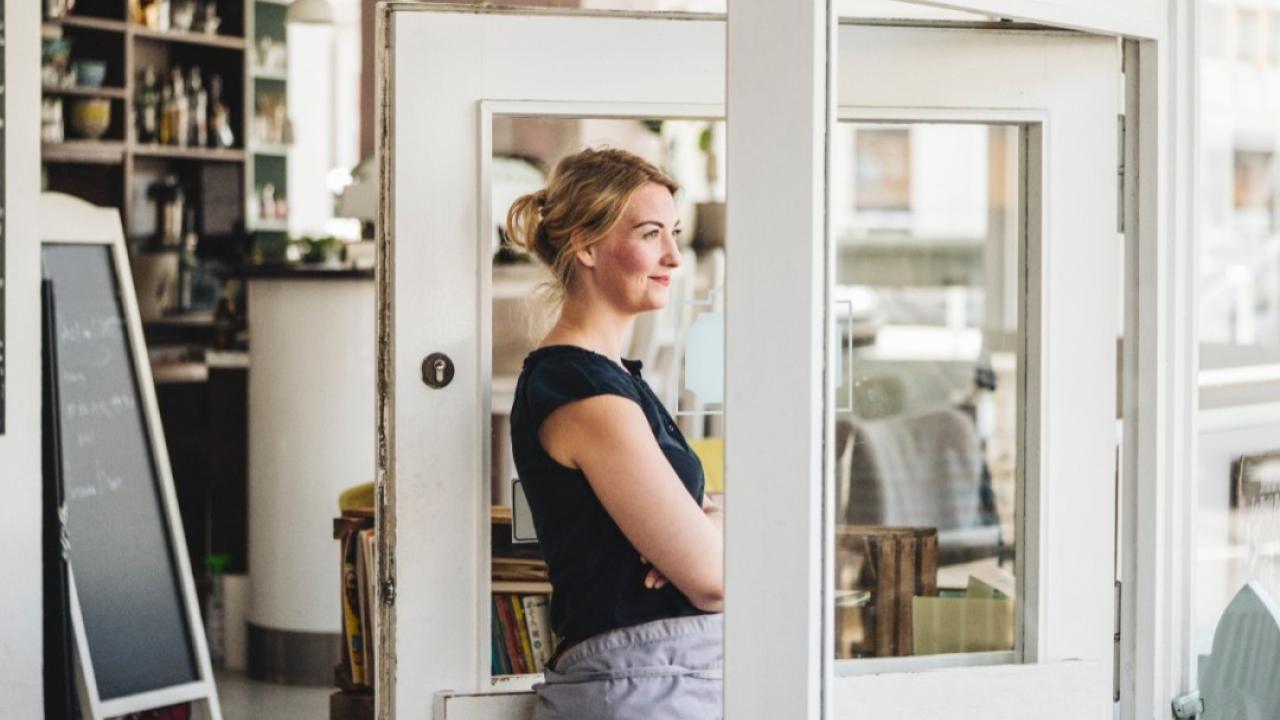 Woman standing by a door.