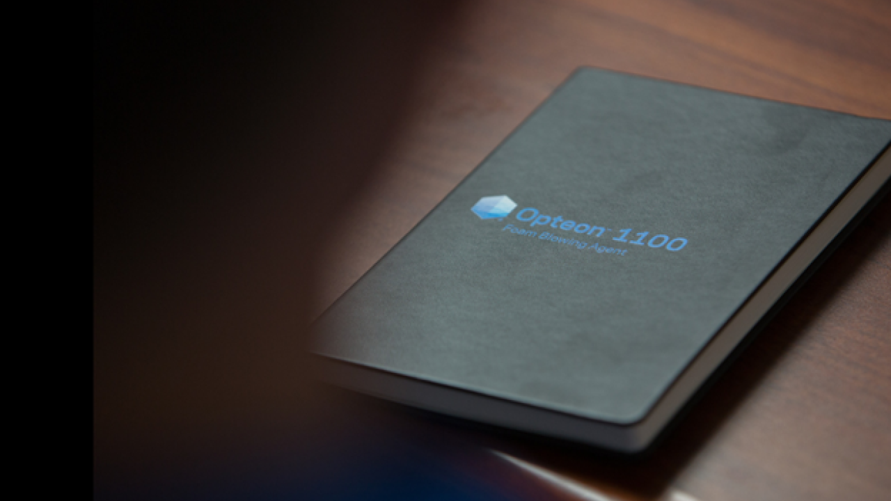 a black book with a logo for Opteon 1100 on the cover