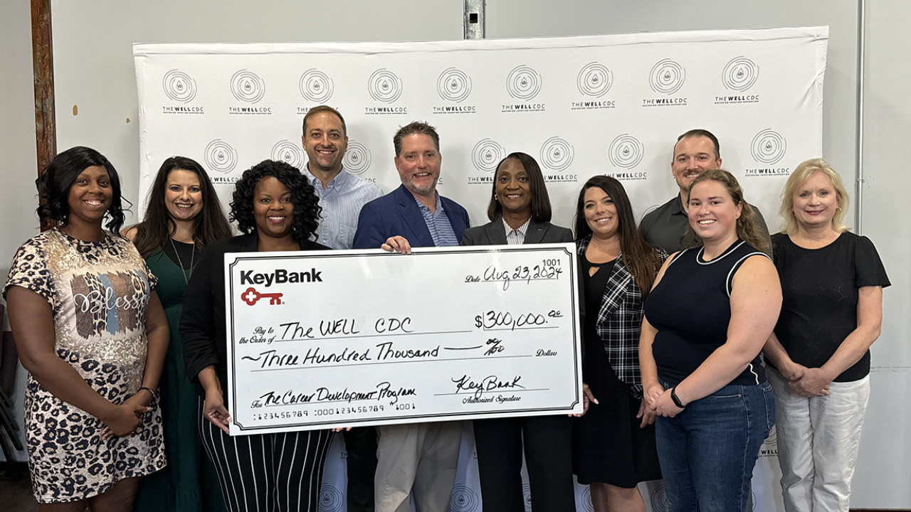 A group of people posing with an oversized check