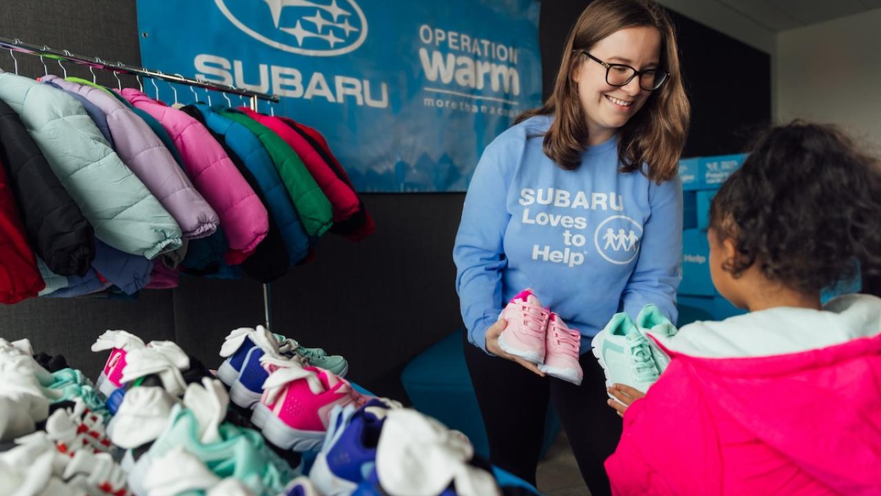 person handing clothes to someone