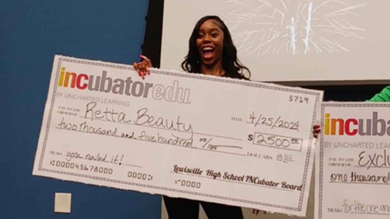 Someone holds an oversized check for Retta Beauty 