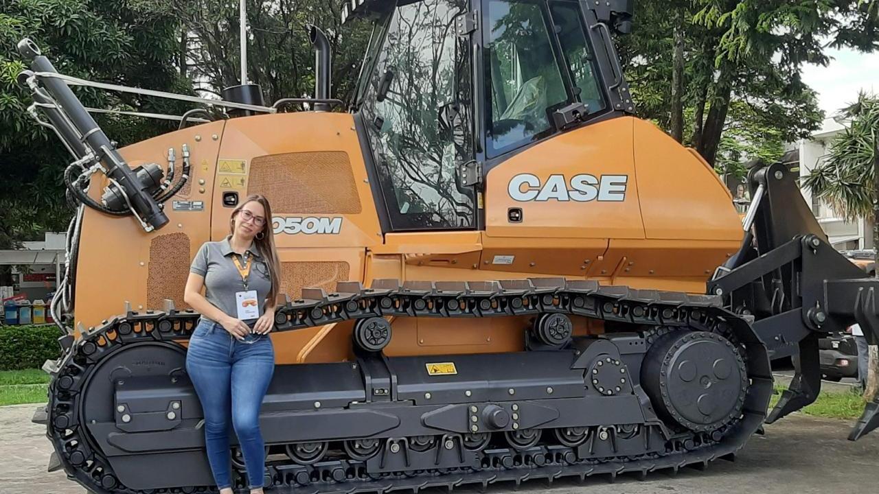 A person leaning against agricultural machinery 