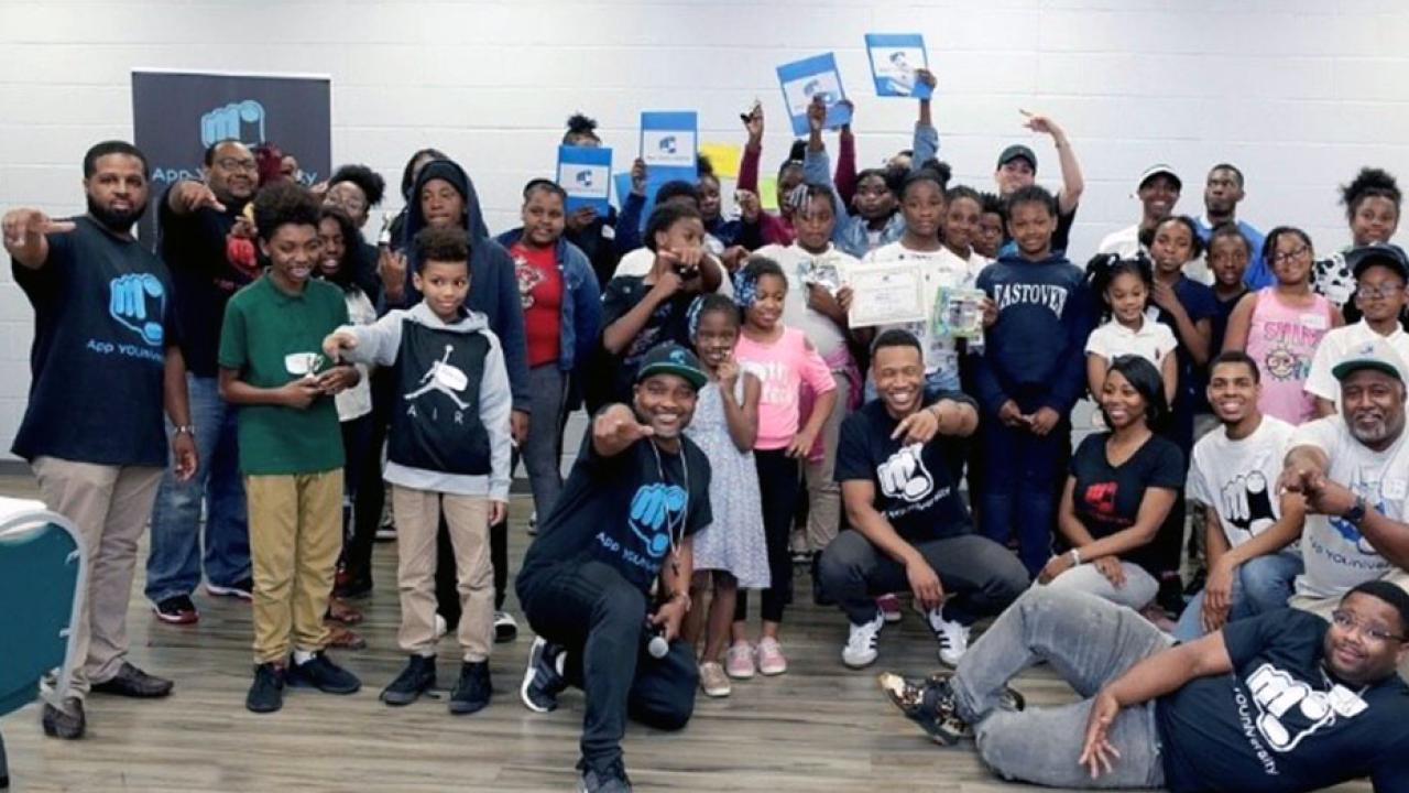 APP YOUniversity students smiling and holding up certificates